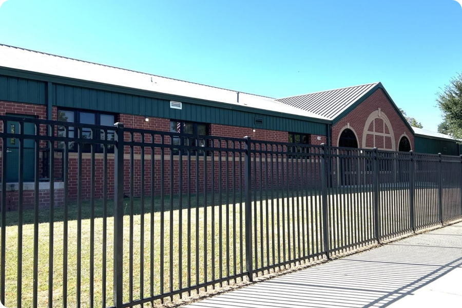 front of school building with a fence